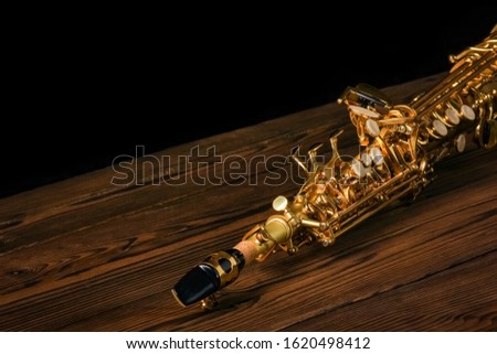 soprano saxophone on black background Royalty-Free Stock Photo #1620498412