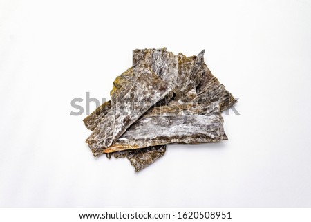 Dry laminaria japonica（kelp）Isolated on white background. Kombu seaweed, traditional Japanese ingredient for cooking Dashi soup, copy space