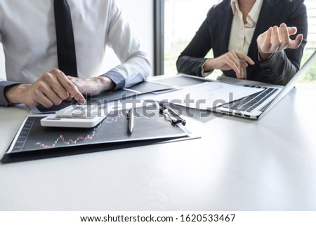 Business team investor on meeting having planning and analyzing of partner cooperation in investment trading marketing project and pointing on the data presented and deal a stock exchange to profit.