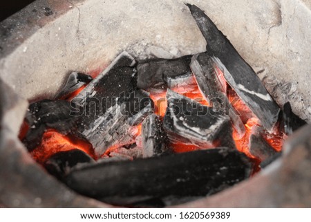 Closeup picture,earthen stove with hot coals inside.