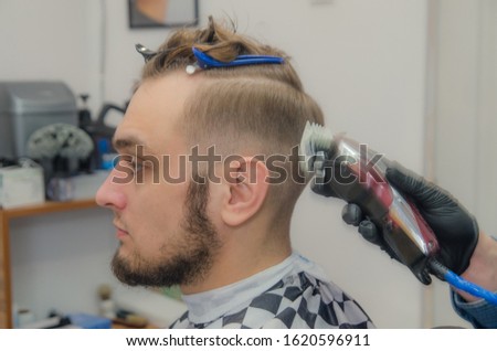 male haircut on a white background. Male hairdresser.