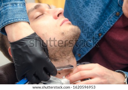 male haircut on a white background. Male hairdresser.