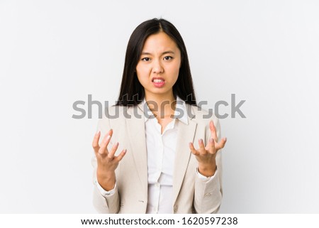 Young chinese business woman isolated upset screaming with tense hands.
