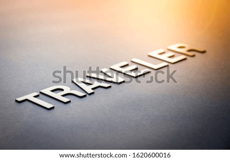 Word traveler written with white solid letters on a board