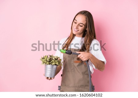 Young caucasian gardener woman isolated