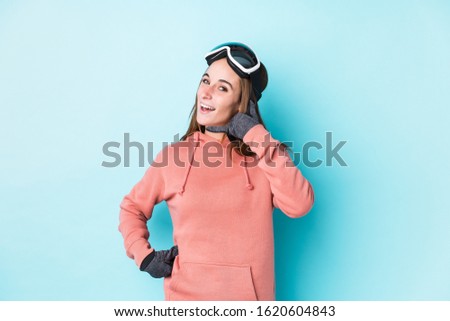 Young skier woman isolated showing a mobile phone call gesture with fingers.