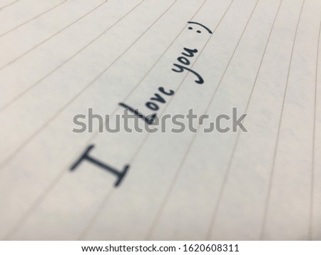 Writing I love you with smile on the paper