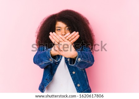 Young african american woman doing a denial gesture