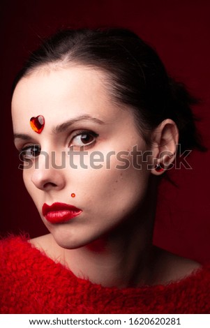 girl in red, red sweater, red lipstick, red nails, emotional portrait