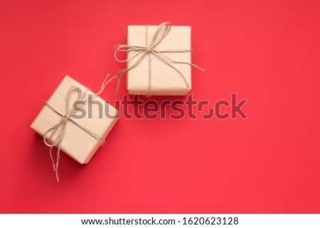 two gifts on a red background in craft paper copy space. Valentine's Day Gift
