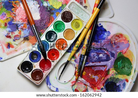 Art palette and brushes with a lot of vivid colors    