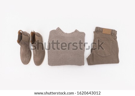 brown color knitted sweater with brown shoes and khaki pants on white background

