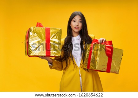 Gift box red ribbon woman yellow coat