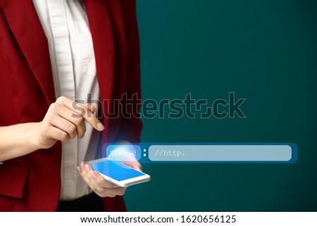 Young woman with mobile phone using web search engine against color background, closeup