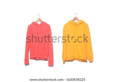 yellow and orange hoodie sweatshirt on hanging

