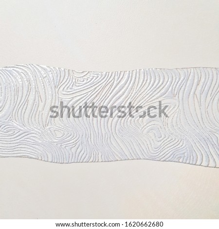 White ceramic tile with abstract silver pattern for wall decor. Concrete stone surface background. Metallic texture of tree bark for interior design project.
