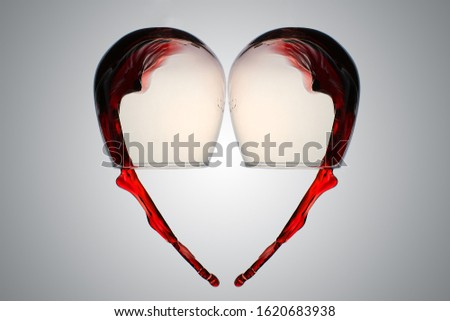 Heart shaped wine splashes.Red wine splashing from wineglass in heart shape.