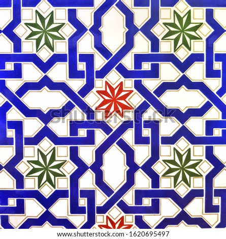 White ceramic tile with geometric and floral pattern for wall and floor decor. Concrete stone surface background. Ornamental texture for interior design project.