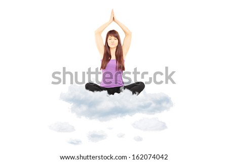 Young female athlete in sportswear sitting on clouds and meditating isolated on white background