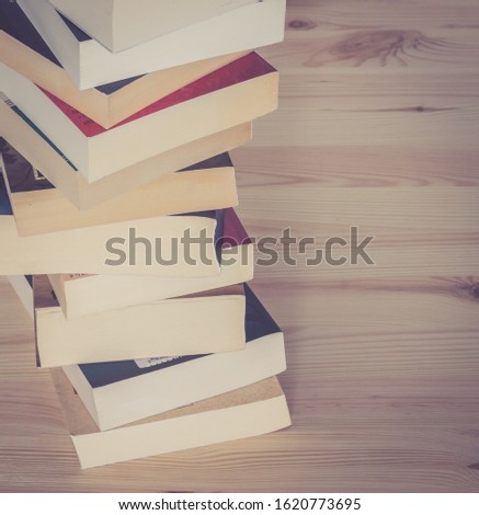 Stack of books on wooden background, knowledge and science 