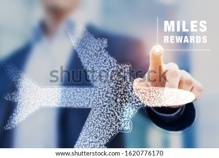 Air miles rewards with person touching airplane shape, frequent flyer loyalty program to earn points and bonuses for travel benefits like elite cards, airport lounge, business or first class flights Royalty-Free Stock Photo #1620776170