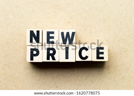 Letter block in word new price on wood background