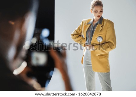 selective focus of stylish model posing for photographer