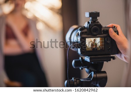selective focus of photographer taking photo of stylish model