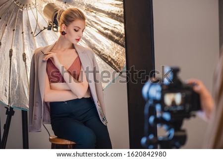 selective focus of stylish and attractive model posing for photographer