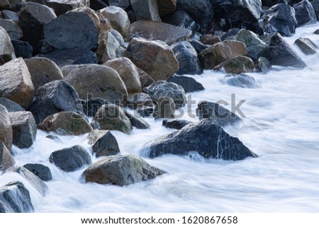Rocks and long exposure waves.