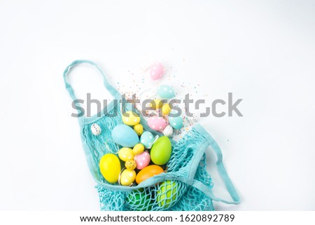 bag with sprinkled Easter eggs on a white background. Background for easter