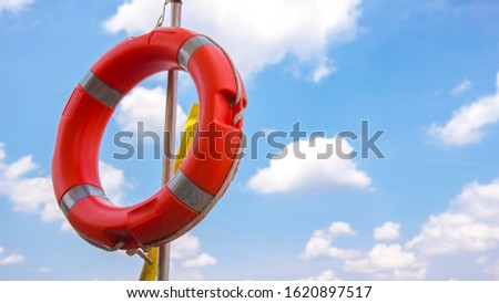 Lifebuoy with clouds in the background