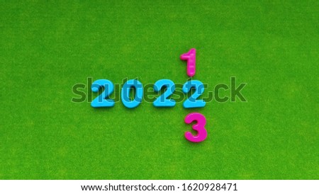 2022 numbers on a green background. The concept of changing the calendar year. New year, future and past.