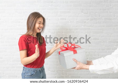 Hands of young man is giving a present to his lovely.