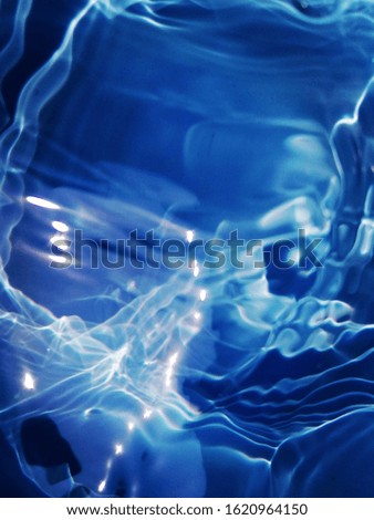 The abstract of blue water texture for background. Art of reflection​ on surface​ blue​ water. Pattern​ of blue​ water​ use​ for background. Blue water​ background​