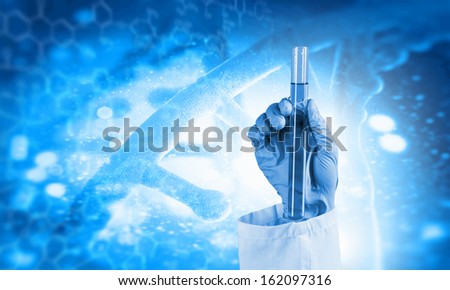 Close up image of human hand holding test tube. Science concept