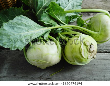    Kohlrabi cabbage on a wooden table, basket                             Royalty-Free Stock Photo #1620974194