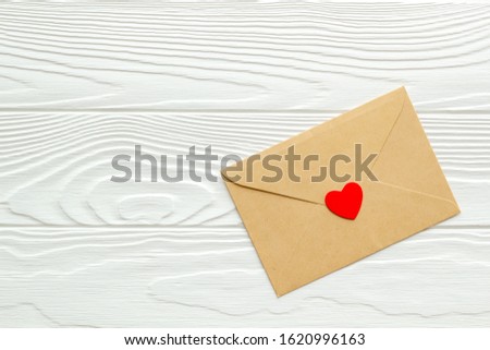 Valentine's Day. Love letter and red box. White wood background top view mockup