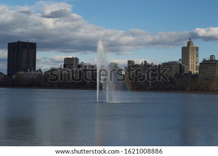 sunlight creates a rainbow in the fountain