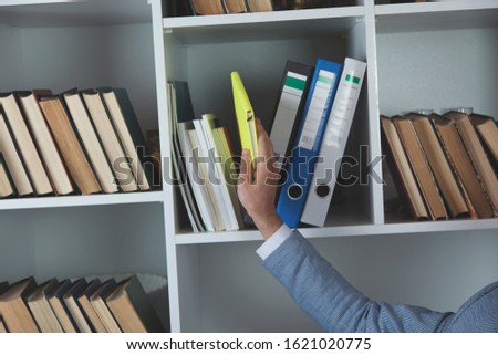 business man with document on wardrobe in office