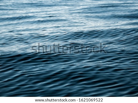 Water texture of deep navy color. Natural background of sea, lake or river surface