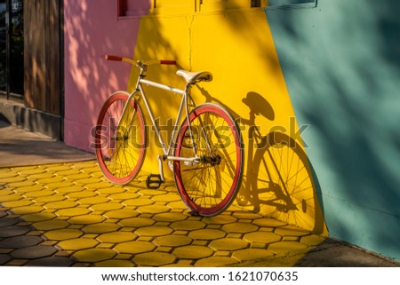 Bicycle against a vibrant wall outdoors, Ecological transportation concept.
