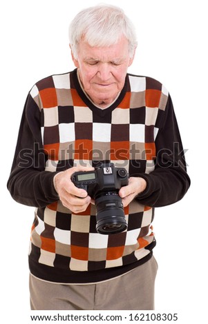 senior man reviewing pictures on SLR camera isolated on white