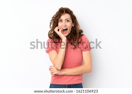 Young pretty woman over isolated background surprised and shocked while looking right