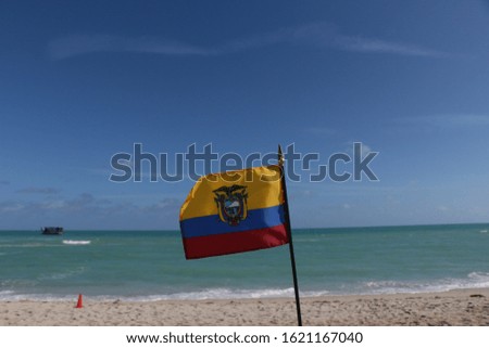 Beautiful National Flag of Ecuador on Tropical Beach