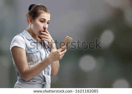 Beautiful woman holding mobile phone checking interesting content
