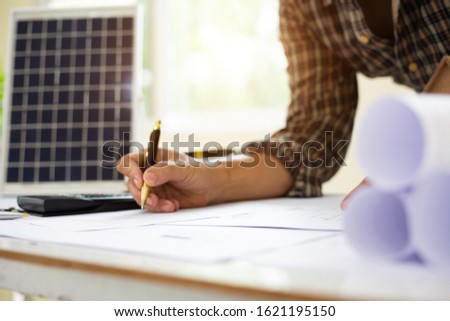 architect man handwriting with blueprint to build houses. After agreeing the employment price the cost of construction and repair real estate