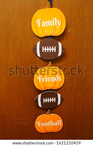 Family, Friends, and Football door hanger decoration hangs on a door for the support the festive of the American Football season. Fond du Lac, Wisconsin 