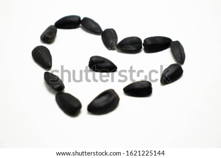 
heart of sunflower seeds on a white background