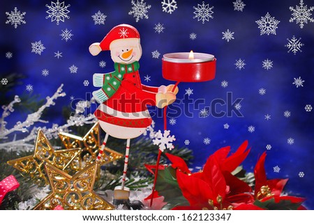 christmas decoration with funny wooden candlestick on dark blue background